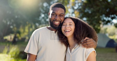 Photo for Love, diversity and a camping couple hugging outdoor in nature together while bonding for adventure. Summer, smile or romance with an interracial man and woman in the woods or forest to explore. - Royalty Free Image