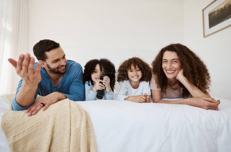 Photo for Bed, happy family children and parents watching tv series, movies or online streaming service, entertainment or video. Bedroom, home and relax mother, father and kids watch show, television or film. - Royalty Free Image