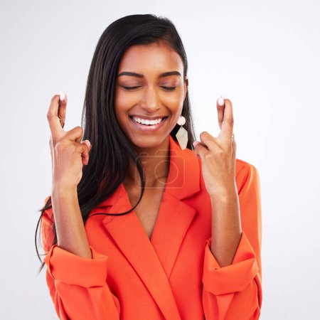 Photo for Face, smile and woman with fingers crossed in studio for good luck, hope or wish on white background. Happy, excited and female model with optimistic hand emoji review ,feedback or waiting for news. - Royalty Free Image
