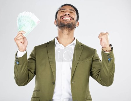 Photo for Money, winner and man with fist celebration in studio for payment, loan or cashback on grey background. Cash, award and Japanese male celebrating investment, growth or financial freedom bingo prize. - Royalty Free Image