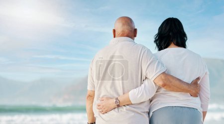 Photo for Space, love and back of old couple at beach for travel, support and summer vacation. Relax, bonding and retirement with senior man and woman hug for trust, health and marriage on banner mockup. - Royalty Free Image