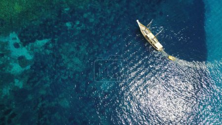 Photo for Aerial, boat and sailing in water, summer on ocean holiday and relax in freedom with nature from above. Yacht vacation, travel in Croatia and tropical cruise on sea adventure to island in sunshine - Royalty Free Image