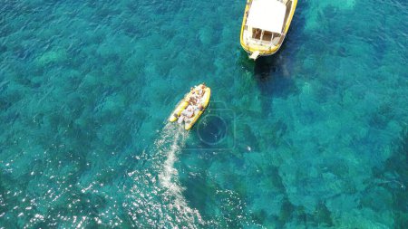 Photo for People on boat from above, sailing in Greece and summer sun on ocean holiday, relax in freedom and nature. Yacht vacation, aerial view of travel and tropical cruise on sea adventure to Greek island - Royalty Free Image