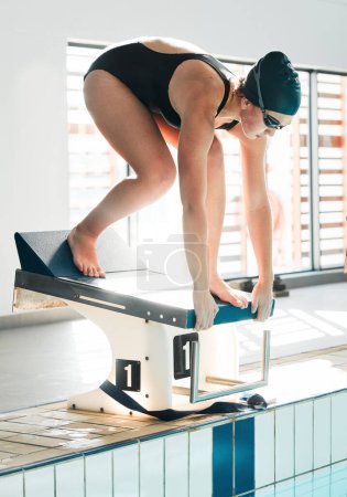Photo for Swimming pool, water sports fitness and woman start challenge, competition or training workout for stroke development. Swimmer, diving block and athlete ready for cardio, match or practice. - Royalty Free Image