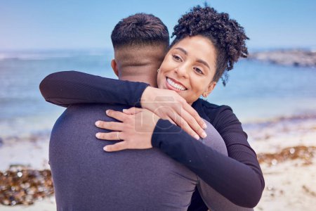 Photo for Fitness, face and couple hug at a beach for sports, training and morning cardio in nature. Love, smile and happy woman embrace man at the ocean for running, workout or wellness exercise with support. - Royalty Free Image
