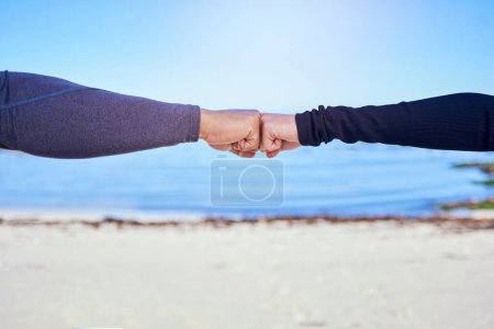 Photo for Fitness, couple and fist bump on the beach for exercise, outdoor workout or celebration in water sports, teamwork and cardio. People, hands and sign of collaboration together in support or success. - Royalty Free Image