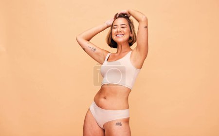 Photo for Happy, lingerie and body of woman in studio isolated on a brown background mockup space. Smile, underwear and model in natural beauty, self love and confidence for positivity, health and wellness. - Royalty Free Image