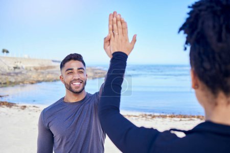 Photo for Fitness, couple and high five on the beach for exercise, outdoor workout or training for water sports, teamwork and healthy cardio. Happy, man and woman athlete with motivation or support in winning. - Royalty Free Image