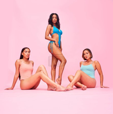 Photo for Women, portrait and friends in swimwear in studio for wellness, beauty or self love. Body positive, swimming costume or fashion swimsuit and model group on pink background for diversity and inclusion. - Royalty Free Image
