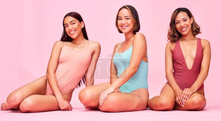 Photo for Diversity, swimsuit and portrait of happy women in studio, sitting together with smile and body positivity. Beauty, summer fashion and bikini models with self love, equality and pink background - Royalty Free Image