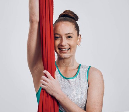 Photo for Portrait, ribbon dancer and competition with a woman in studio on a gray background for routine training. Fitness, smile and energy with a happy athlete holding fabric for a performance showcase. - Royalty Free Image