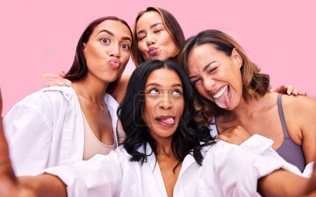 Photo for Girl group, studio selfie and funny face with solidarity, diversity and happy for blog by pink background. Women friends, comic memory and smile for photography, memory and post on social network. - Royalty Free Image
