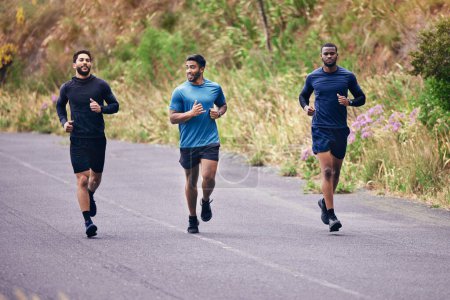 Photo for Fitness, men and running friends in a road for training, speed and energy, health and cardio routine in nature. Sports, diversity and man group on practice run for competition, workout or race goal. - Royalty Free Image
