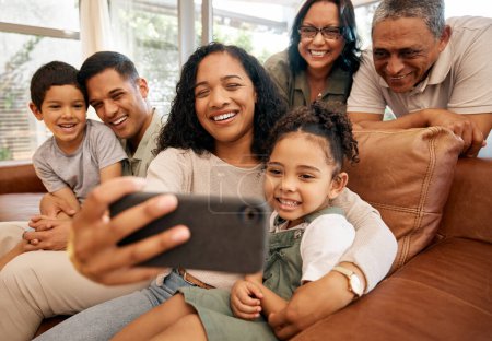 Photo for Big family, selfie and grandparents with children on sofa for holiday, love and relax together at home. Interracial people, mother and father with kids smile on couch for profile picture photography. - Royalty Free Image