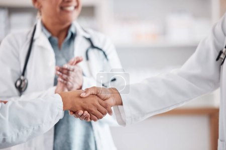 Photo for Clapping, teamwork or doctors shaking hands for success, good job or promotion goal in a hospital meeting. Closeup, congratulations or proud healthcare worker with handshake for medical collaboration. - Royalty Free Image