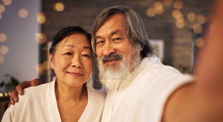 Photo for Selfie, relax and love with old couple at spa for social media, anniversary and celebration. Beauty treatment, massage and profile picture with portrait of Asian man and woman at hotel for wellness. - Royalty Free Image
