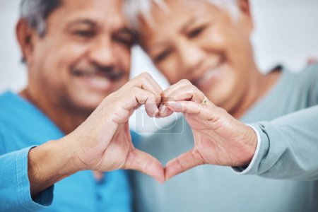 Photo for Heart, mature couple and hands for care in healthy relationship, connection or commitment to marriage. Love sign, romance of man and woman in loyalty, kindness or emoji to support in trust together. - Royalty Free Image