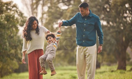 Photo for Holding hands, park and parents play with kid in nature for fun, bonding and relax together. Happy family, childhood and mother, father and young boy jump outdoors on holiday, adventure and vacation. - Royalty Free Image