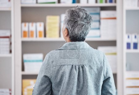 Photo for Patient, pharmacy and checking pharmaceutical shelf for medication, healthcare or boxes at the drugstore. Rear view of customer in search for medical product, supplements or antibiotics at the clinic. - Royalty Free Image