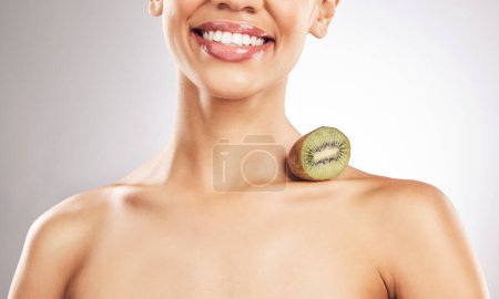 Photo for Skincare, kiwi and woman in studio smile for natural, beauty or treatment or eco friendly cosmetics on white background. Wellness, skin and female model with fruit for collagen, detox or vitamin C. - Royalty Free Image