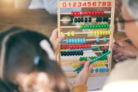 Photo for Kid, math homework or grandma teaching or helping for knowledge, education or child development. Grandparent, senior grandmother or back of girl counting numbers to study for test on abacus at home. - Royalty Free Image