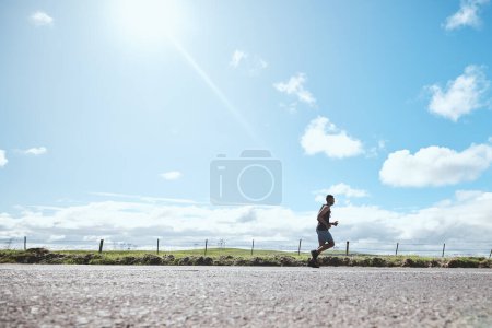 Photo for Marathon runner, fitness and man on road outdoor, cardio or healthy body. Athlete training, sport and exercise in competition, workout energy or race on street in wellness at countryside mockup space. - Royalty Free Image