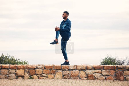Photo for Fitness, man stretching legs and outdoor running workout on road for health and wellness. Sports, motivation and healthy mindset, training and stretch for runner exercise or marathon with headphones - Royalty Free Image