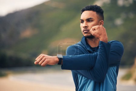 Photo for Runner man, stretching arms and mountain with thinking for fitness, health or wellness in street. Young guy, outdoor and start training in morning for marathon with idea, vision and warm up in nature. - Royalty Free Image