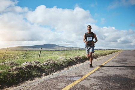 Photo for Exercise, marathon runner and man on road outdoor, cardio or healthy body. Athlete, training and fitness in race competition, workout energy or sport on street in wellness at countryside mockup space. - Royalty Free Image