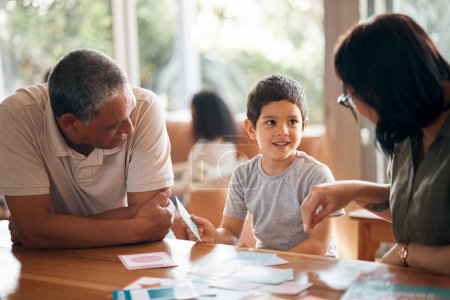 Photo for Home school, learning and parents support child with lesson and flash cards for education. Studying, kid and grandfather with teaching, communication and bonding from development and conversation. - Royalty Free Image