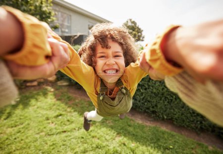 Photo for Kid, spin and outdoor in pov, holding hands and happy for game with parent, holiday or backyard. Excited young child, smile and swing in air, fast and grass for play on vacation, sunshine or portrait. - Royalty Free Image