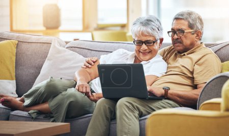 Photo for Laptop, relax and senior couple on sofa for watching movies, entertainment and streaming in living room. Retirement, love and happy man and woman on computer for internet, website and film at home. - Royalty Free Image