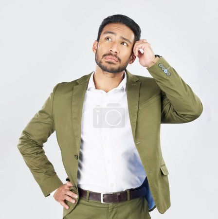 Photo for Business man, thinking and vision in studio with ideas, confused and questions by white background. Indian entrepreneur, brainstorming and remember for decision, choice and problem solving in career. - Royalty Free Image