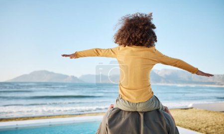 Photo for Father, child on shoulders and freedom at beach, bonding and piggyback, fun and games with back view. Man, young girl and playing, summer and care, love and adventure with parenting and childhood. - Royalty Free Image