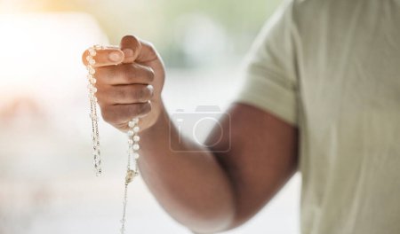 Photo for Rosary, man hand and faith with prayer beads in home with hope, christian praise and religion. Praying, necklace and worship in house with hope, gratitude and spiritual guide for support and healing. - Royalty Free Image
