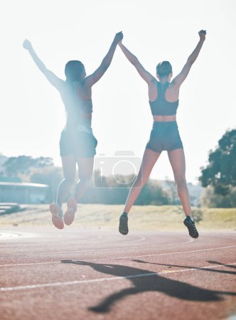 Photo for Friends, fitness and jump, women and celebrate, winning race and energy, wellness and health with support outdoor. Excited, people in air and cardio with sport, success and workout together with back. - Royalty Free Image