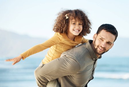 Photo for Father, kid and piggyback, happiness at beach with bonding and travel, fun and games together. Man, young girl and playing, summer and smile with care, love and adventure with parenting and childhood. - Royalty Free Image
