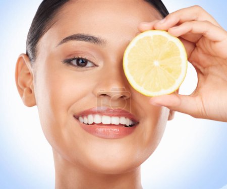 Photo for Beauty skincare, portrait and happy woman with lemon for citrus detox treatment, natural self care or wellness. Vitamin C food, fruit product and studio face of dermatology person on blue background. - Royalty Free Image
