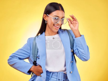 Photo for Fashion, student or portrait of woman in sunglasses on yellow background with trendy clothes or smile. Girl, happy person and excited gen z model with cool style, bag or elegant outfit in studio. - Royalty Free Image