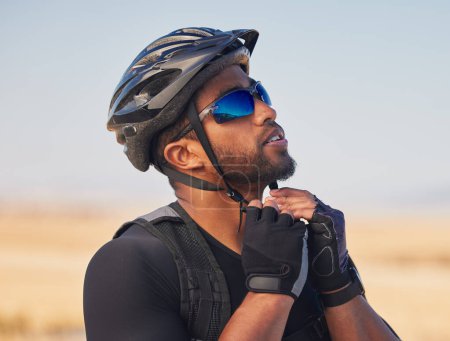 Photo for Cycling, sports and fitness with man and helmet in road for training, challenge and performance, Health, workout and wellness with person and safety gear in nature for freedom, adventure and exercise. - Royalty Free Image