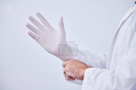 Photo for Doctor, hand and glove for medical or health care with hygiene, medicine and wellness in studio. Closeup of a professional person with ppe for safety, protection and insurance on a white background. - Royalty Free Image