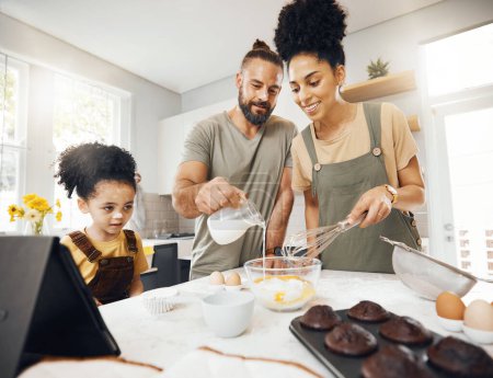 Photo for Child, parents and baking in kitchen, teaching and learning for development at breakfast. Cupcake, cooking and boy in home with happy interracial family, mom and dad and mixing muffins in the morning. - Royalty Free Image
