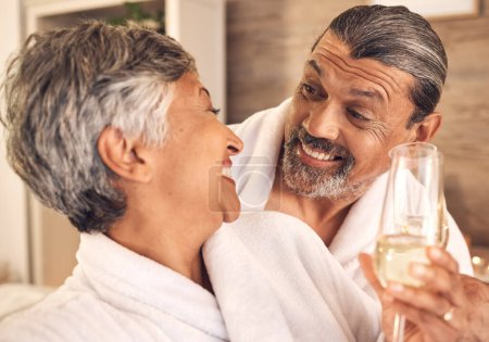 Photo for Love, champagne and relax with old couple in spa for anniversary, celebration and happy. Wellness, massage and marriage with senior man and woman in villa for luxury, vacation and peace together. - Royalty Free Image
