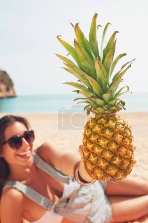 Photo for Beautiful happy Woman holding Exotic Pineapple fruit symbol of summer beach vacation healthy organic diet food. - Royalty Free Image