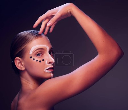 Photo for Woman, beauty and paint in studio portrait, profile or art for wellness, fantasy or cosmetic by dark background. Girl, model and facial painting for skin, creativity or pattern with makeup for change. - Royalty Free Image