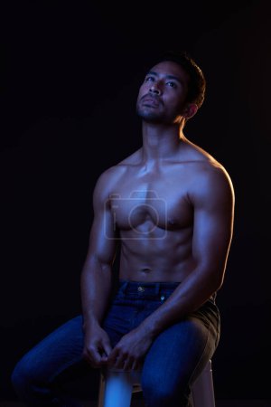 Photo for Topless, sexy and man in neon studio for fitness inspiration, beauty aesthetic or sensual fantasy. Erotic art, sexual body and male model thinking with muscle, black background and dark blue lighting. - Royalty Free Image