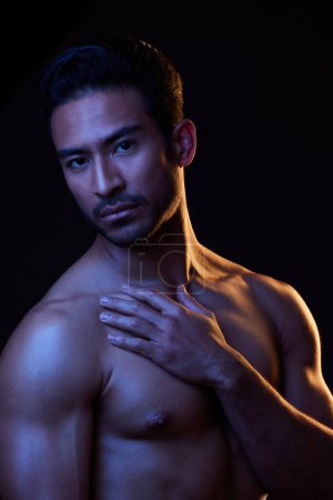 Photo for Sexy, dark portrait and man on black background in fitness inspiration, beauty aesthetic or sensual fantasy. Erotic, sexual body and topless seductive male model with muscle, studio and neon lighting. - Royalty Free Image