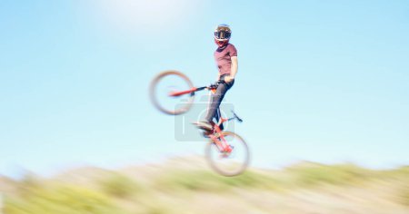 Photo for Blur, air and cyclist cycling in nature training for a competition on trail or path in forest or woods. Freedom, wheelie stunt or athlete riding bicycle to jump in cardio exercise, fitness or workout. - Royalty Free Image