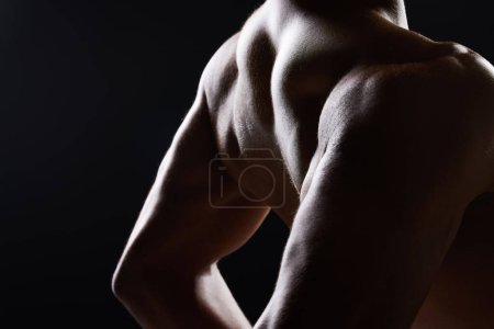Photo for Man, back and shirtless in dark studio with shadow for wellness, health and strong by black background. Model guy, silhouette and fitness with skin, aesthetic and muscle with power in dark for art. - Royalty Free Image