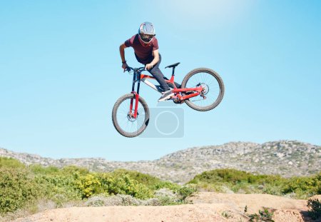 Photo for Freedom, air and man cycling in nature training for a sports competition on trail or path on mountain. Action, stunt or cyclist athlete riding bicycle to jump for cardio exercise, fitness or workout. - Royalty Free Image
